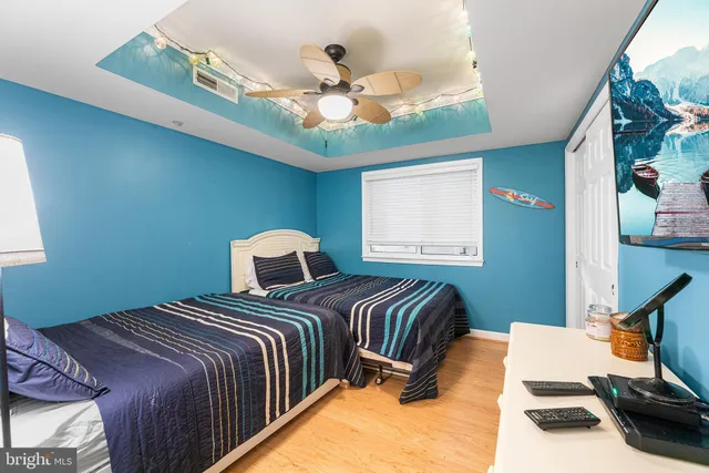 a bedroom with two beds and a chandelier