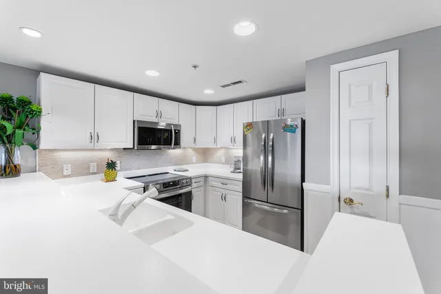 a very nice looking dining room with furniture and a chandelier