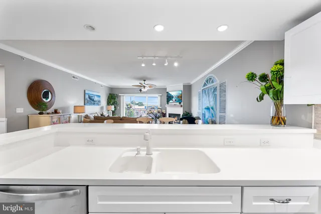 a kitchen with stainless steel appliances a dining table chairs and a refrigerator