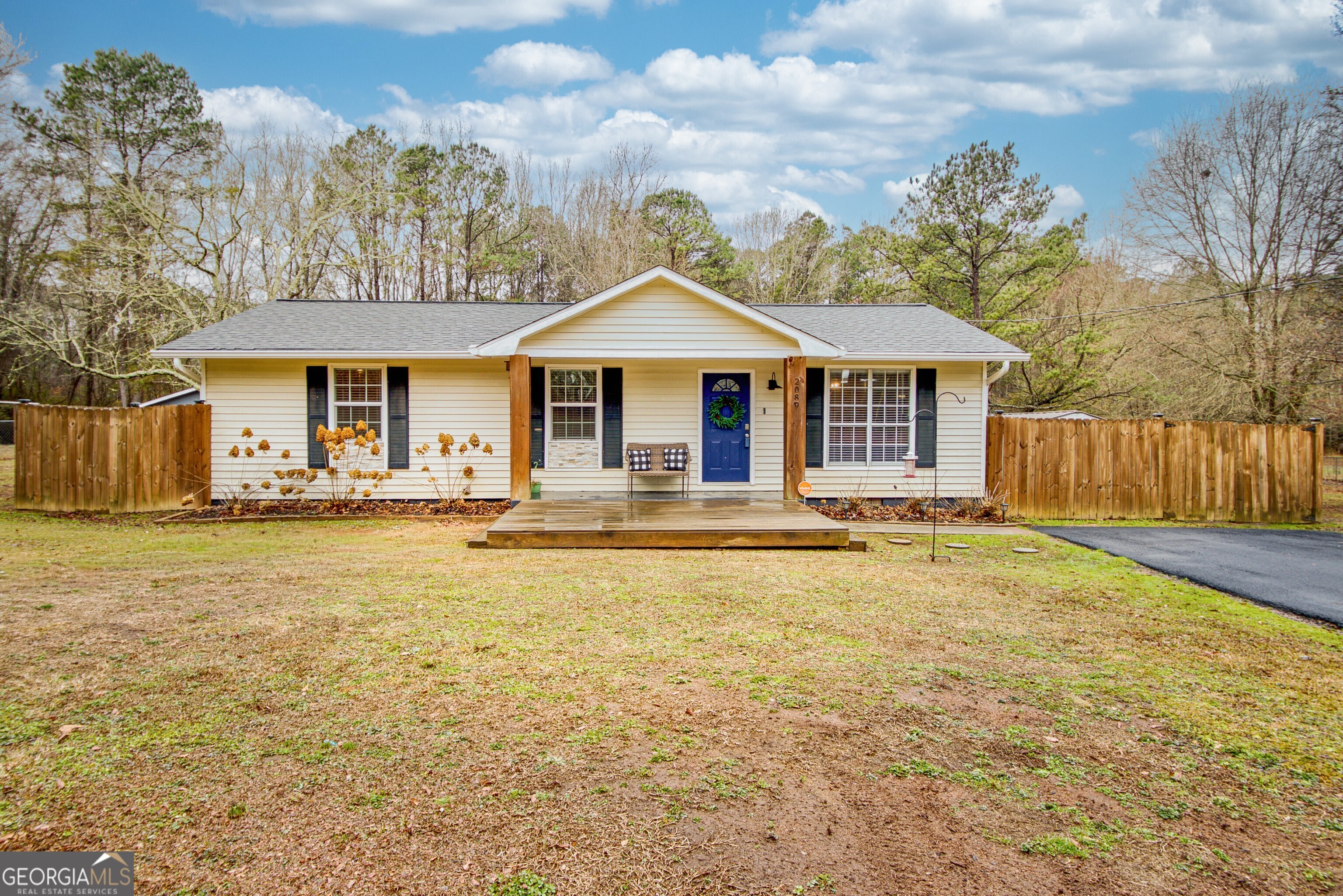 a front view of a house with a yard outdoor seating and garage