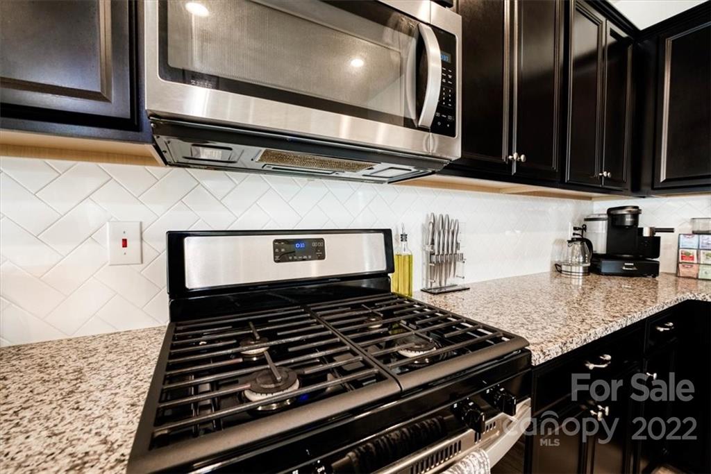 14015 Ridgewater Way Charlotte, NC 28278 - Photo 12 of 48 a stove top oven sitting inside of a kitchen