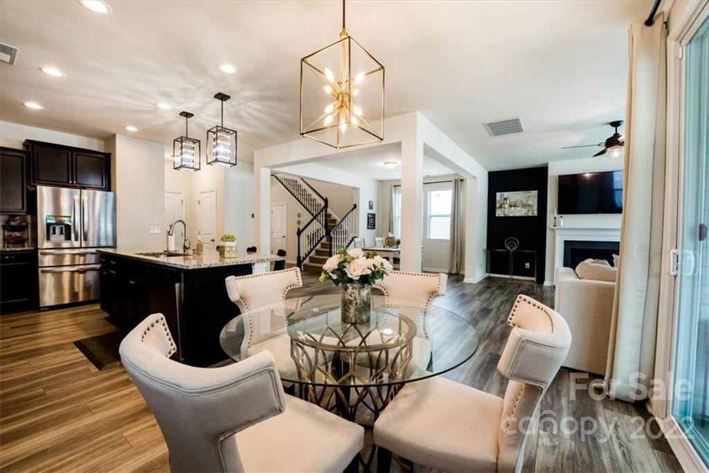 14015 Ridgewater Way Charlotte, NC 28278 - Photo 15 of 48 a view of a dining room with furniture and wooden floor