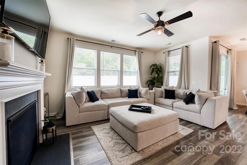 14015 Ridgewater Way Charlotte, NC 28278 - Photo 16 of 48 a living room with furniture a fireplace and a large window