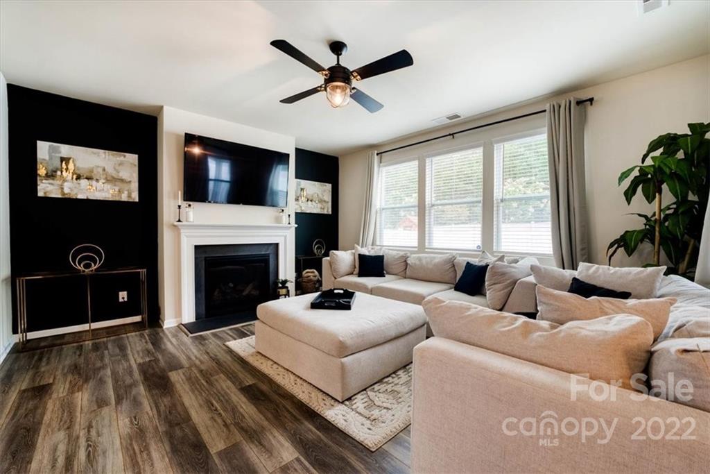 14015 Ridgewater Way Charlotte, NC 28278 - Photo 17 of 48 a living room with furniture a fireplace and a flat screen tv