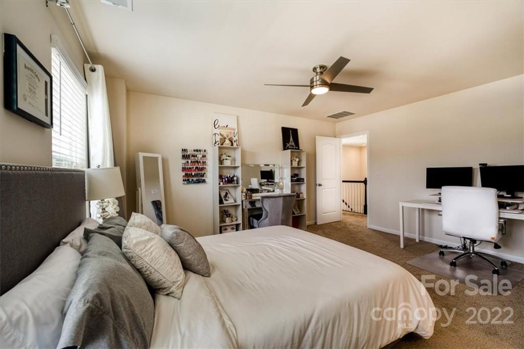 14015 Ridgewater Way Charlotte, NC 28278 - Photo 22 of 48 a bedroom with a bed and a flat screen tv