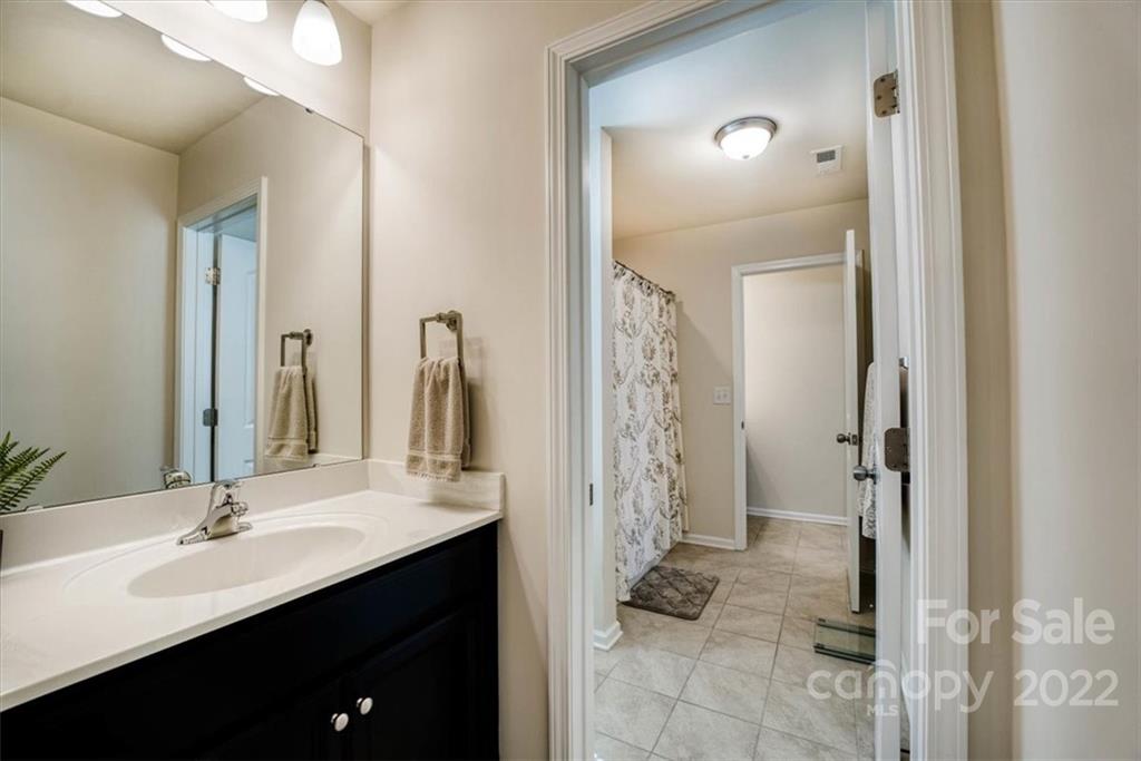 14015 Ridgewater Way Charlotte, NC 28278 - Photo 27 of 48 a bathroom with a double vanity sink a toilet and a mirror