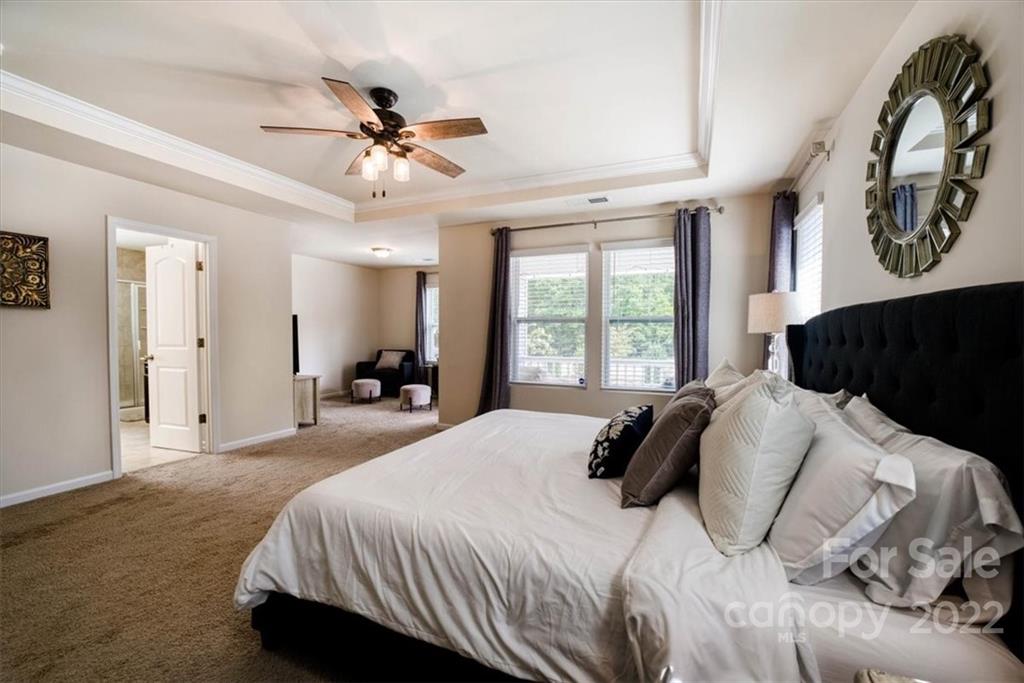 14015 Ridgewater Way Charlotte, NC 28278 - Photo 32 of 48 a bedroom with a large bed and a chandelier