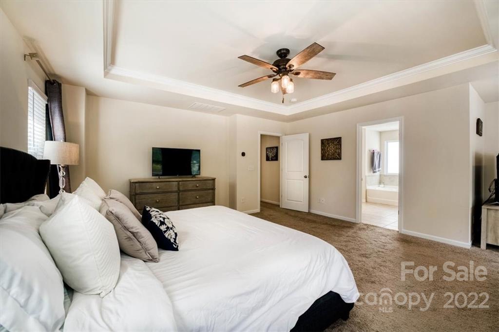 14015 Ridgewater Way Charlotte, NC 28278 - Photo 33 of 48 a bedroom with a bed and a flat screen tv