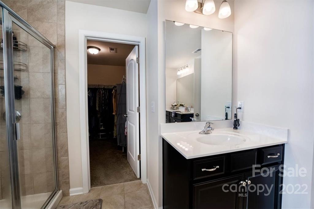 14015 Ridgewater Way Charlotte, NC 28278 - Photo 36 of 48 a bathroom with a sink a mirror and a shower