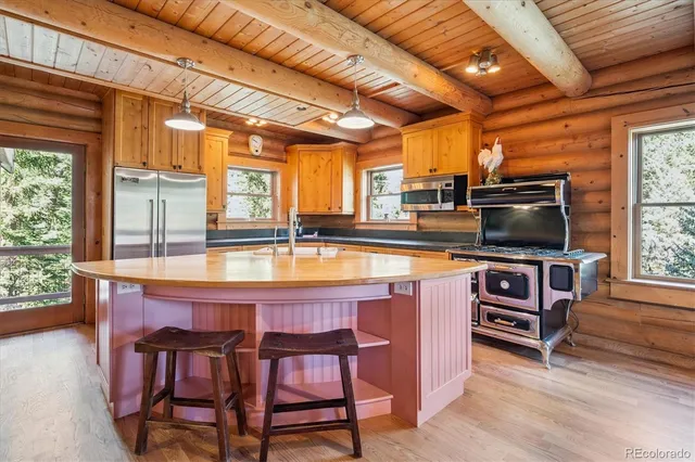 a kitchen with a stove a sink and a microwave