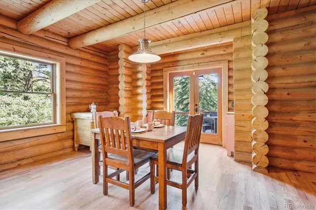 a dining room with furniture and wooden floor