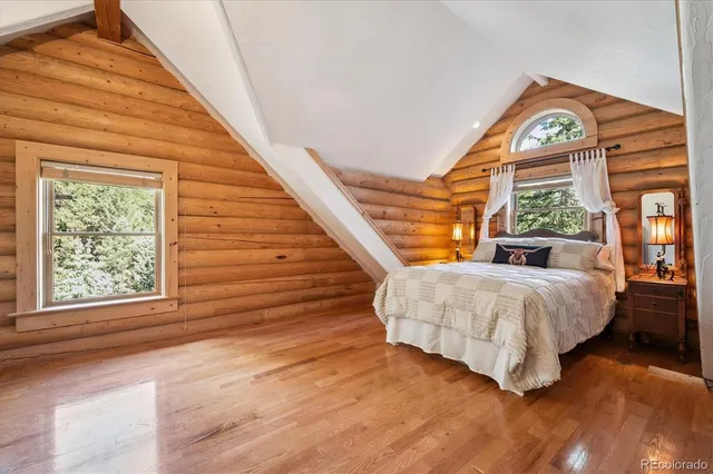 a bed sitting in a bedroom next to a window
