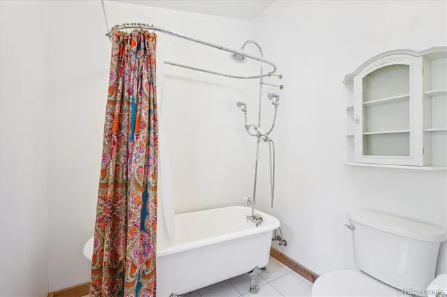 a bathroom with a shower curtain and a bathtub