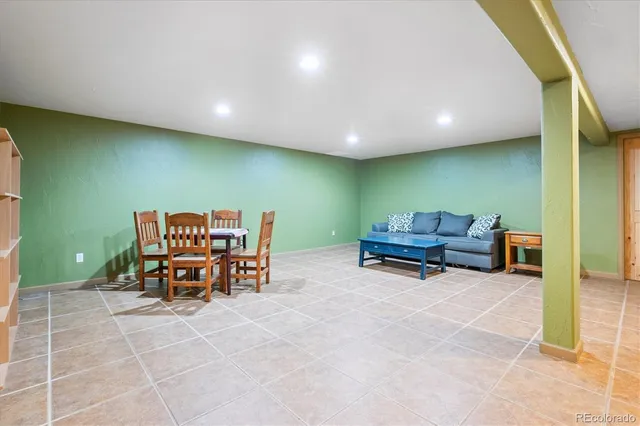 a living room with furniture and a gym equipment