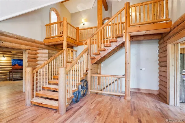 a view of entryway with wooden floor and stairs