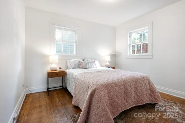 a bedroom with a bed and painting on the wall