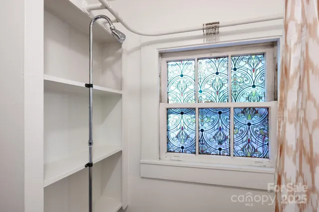 a view of backyard with table and chairs and potted plants
