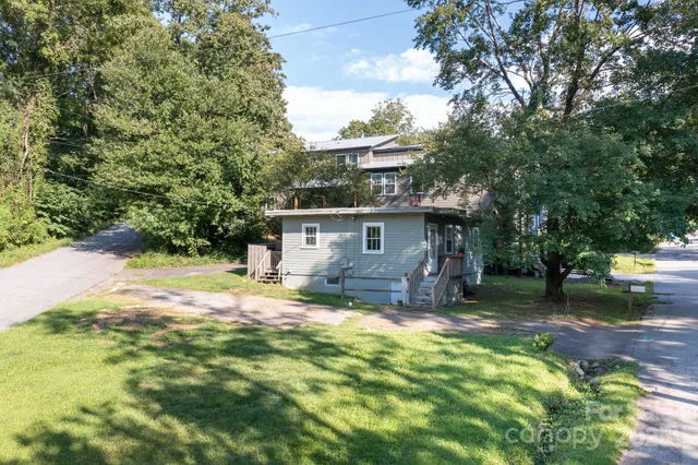 a view of house with outdoor seating and yard