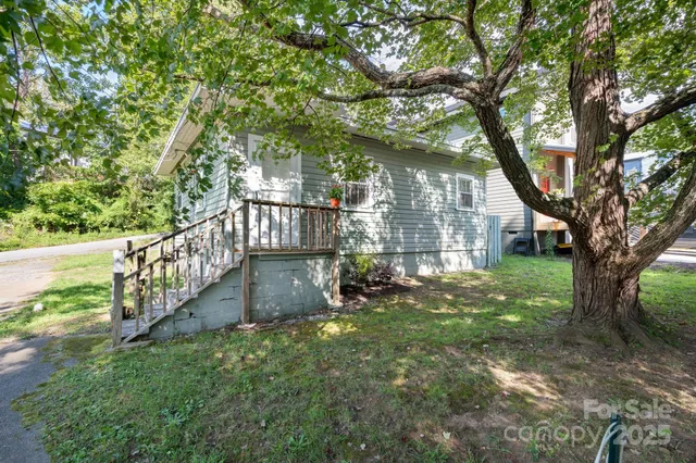 a view of a yard with large trees