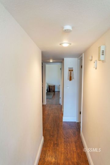 644 Beth Lane Ridgecrest, CA 93555 - Photo 11 of 31 a view of a hallway with wooden floor and a living room