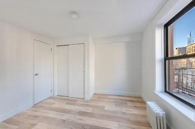 a view of room with window and hardwood floor