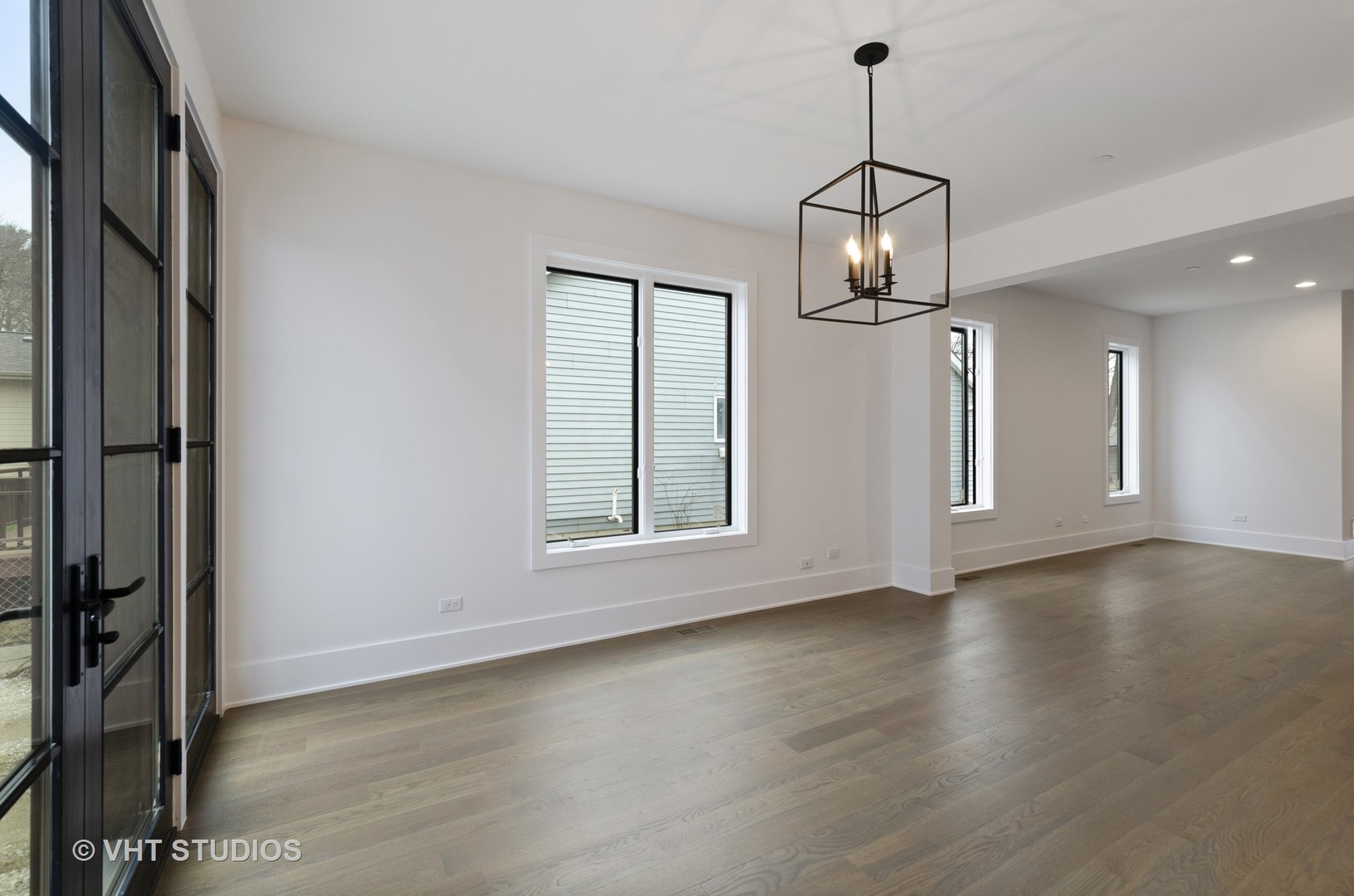 717 Meadow Lane Libertyville, IL 60048 - Photo 11 of 23 a view of an empty room with wooden floor and a window