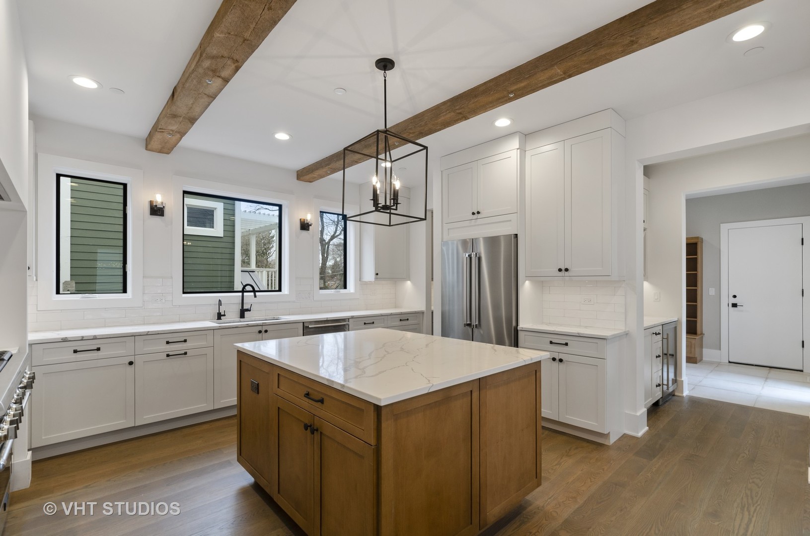 717 Meadow Lane Libertyville, IL 60048 - Photo 3 of 23 a large kitchen with stainless steel appliances granite countertop a sink and dishwasher a refrigerator with wooden floor