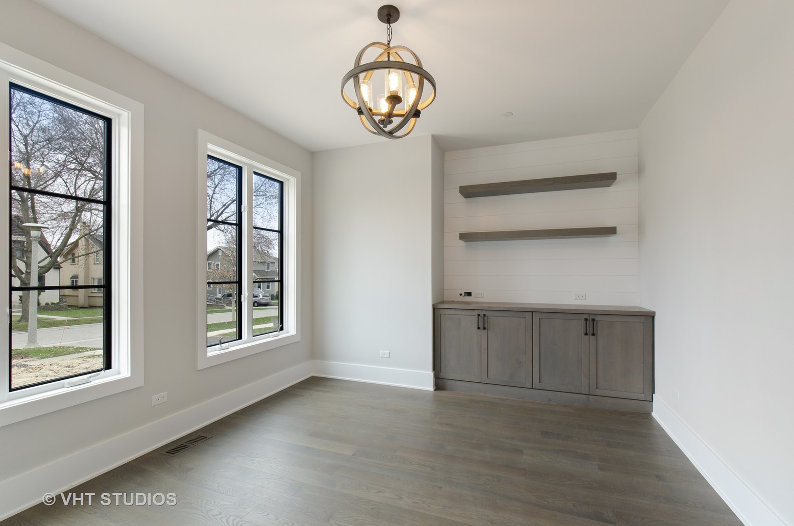 717 Meadow Lane Libertyville, IL 60048 - Photo 9 of 23 an empty room with wooden floor cabinet and windows