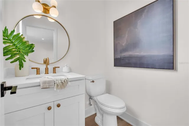 a bathroom with a sink a mirror and a toilet