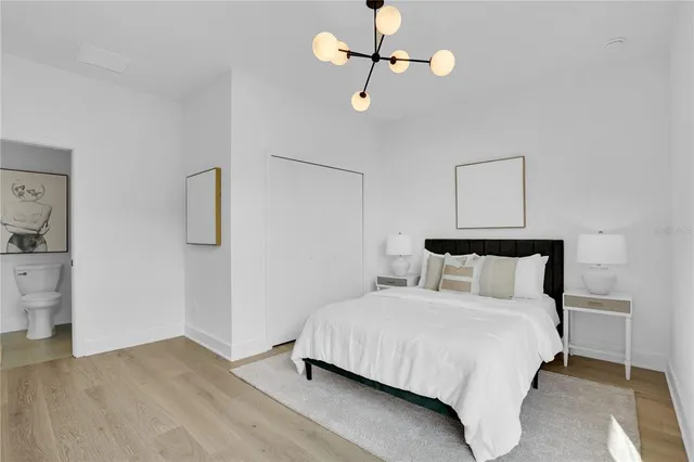 a bedroom with a bed and a night stand