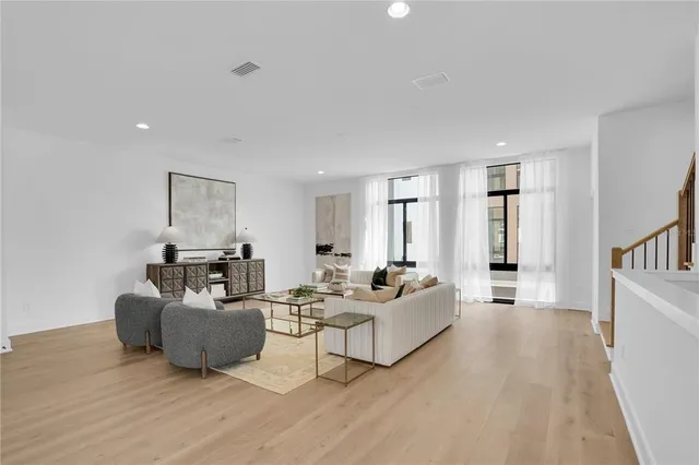 a living room with furniture and a wooden floor