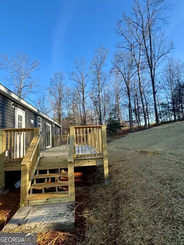 a view of wooden house with a yard
