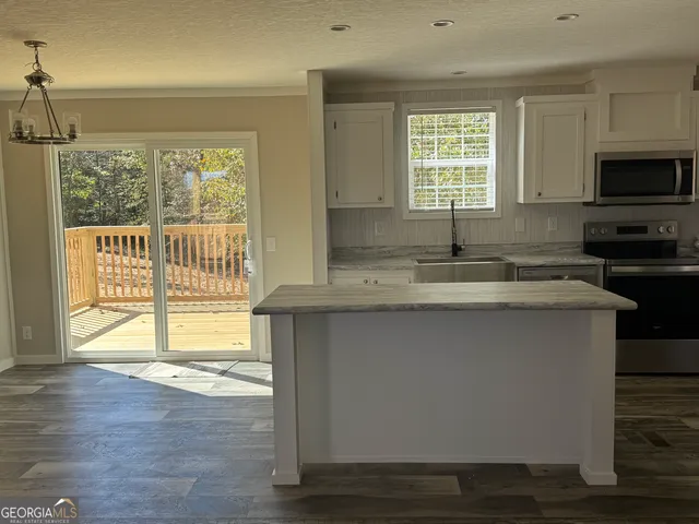a kitchen with a sink a window and a counter top space