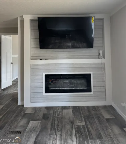 a living room with a fireplace and a flat screen tv