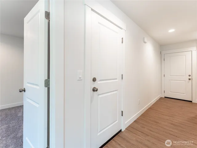 a view of a hallway with wooden floor