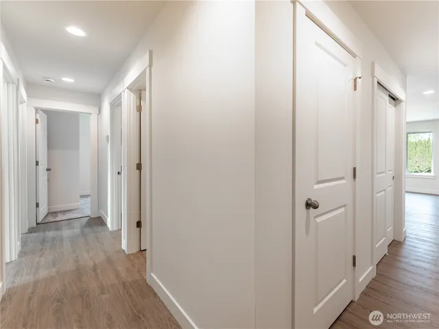 a view of a hallway with wooden floor