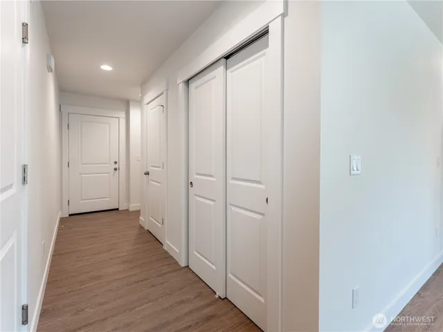 a view of a hallway with wooden floor