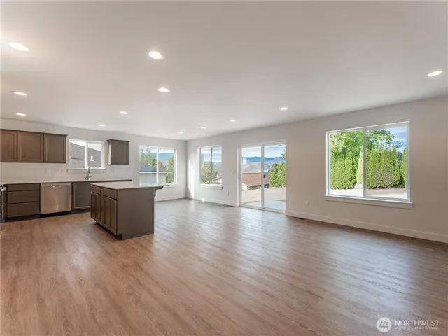 a large kitchen with a lot of counter space and a wooden floor