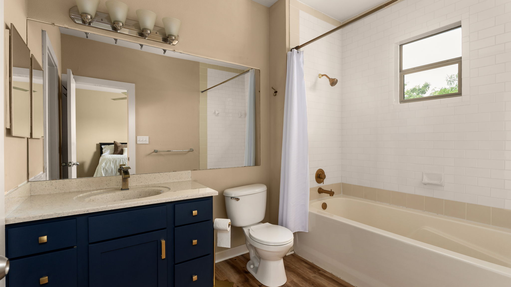 1201 Grove Boulevard, Unit 2802 Austin, TX 78741 - Photo 12 of 21 a bathroom with a bathtub shower sink vanity mirror and toilet