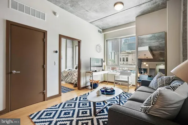 a living room with furniture a rug and a chandelier
