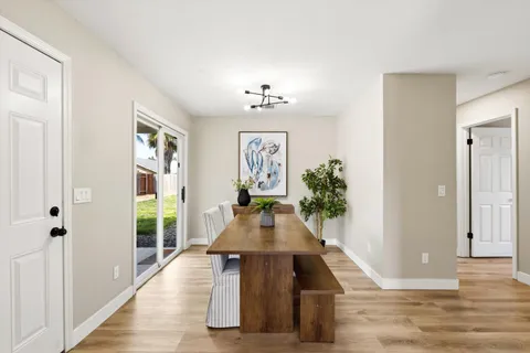 a living room with furniture floor to ceiling window and wooden floor