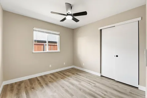 a view of empty room with wooden floor