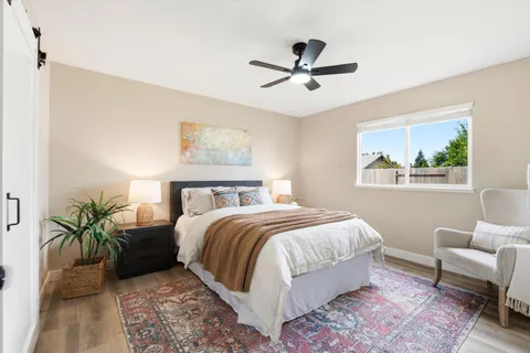a bedroom with a large bed and a window