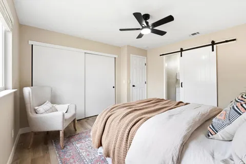 a bedroom with a bed and a chair