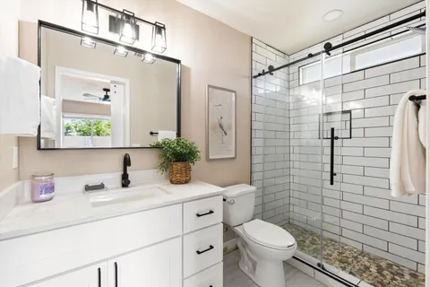 a bathroom with a sink toilet and shower