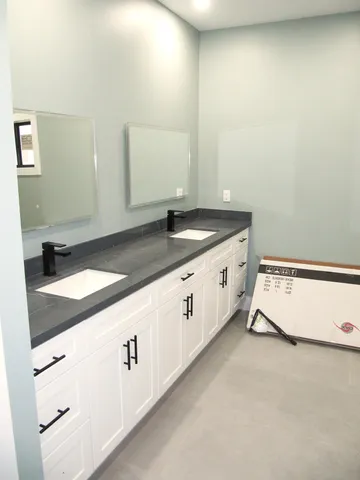 an empty room with windows and a ceiling fan