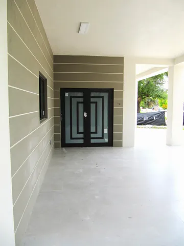 a view of an empty room with a fireplace and a large window