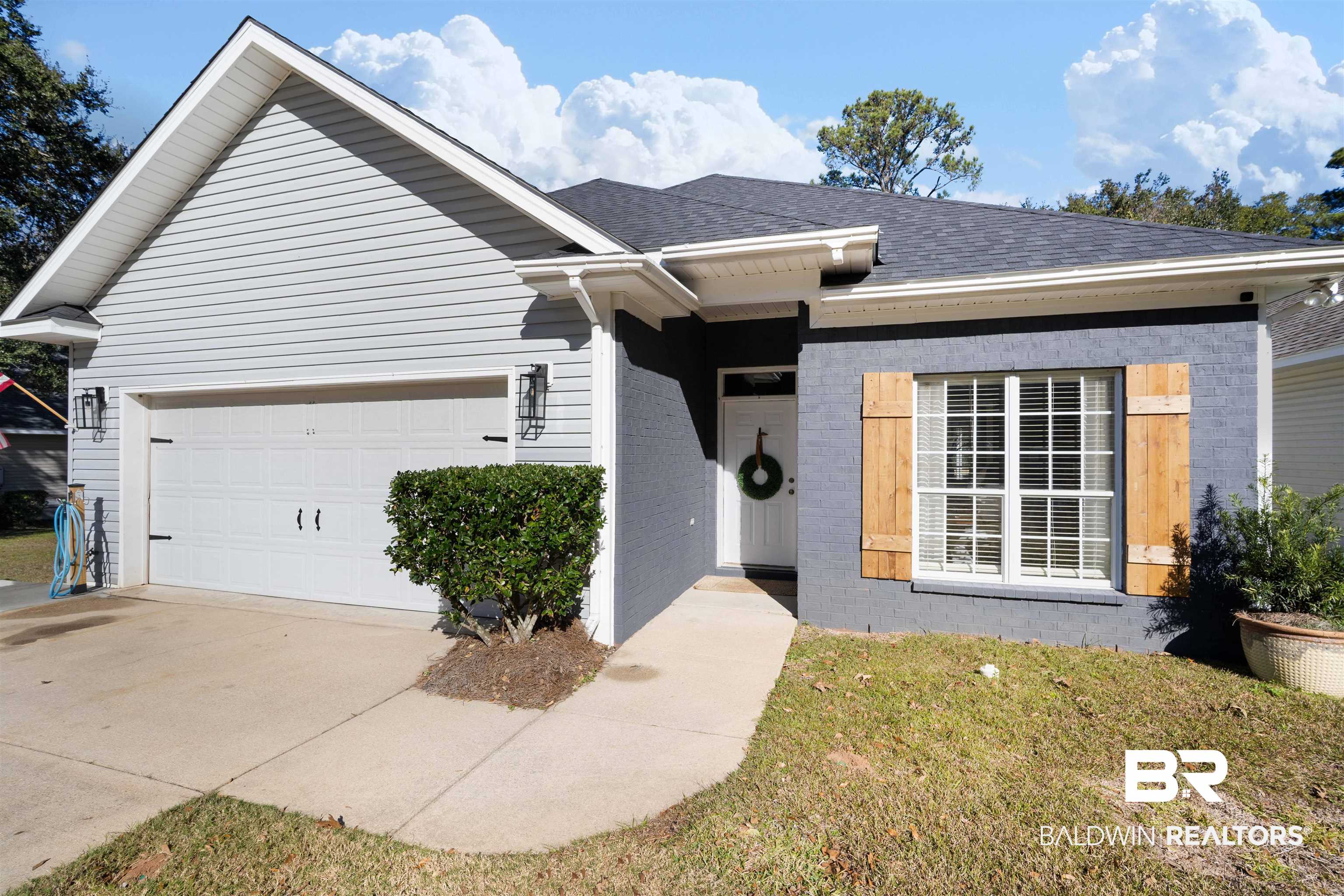 27288 Parker Lane Daphne, AL 36526 - Photo 1 of 29 View of front facade with brick siding, roof with shingles, driveway, a front yard, and an attached garage