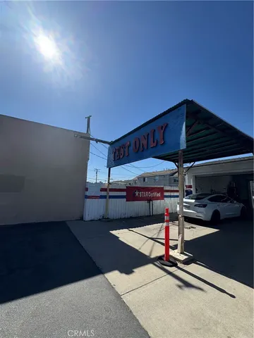 a view of a street with a cars parked on the road