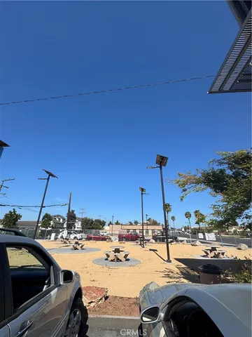 a view of a street with cars parked on road